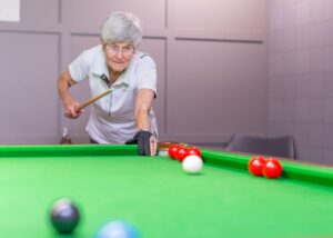 Woman resident playing snooker